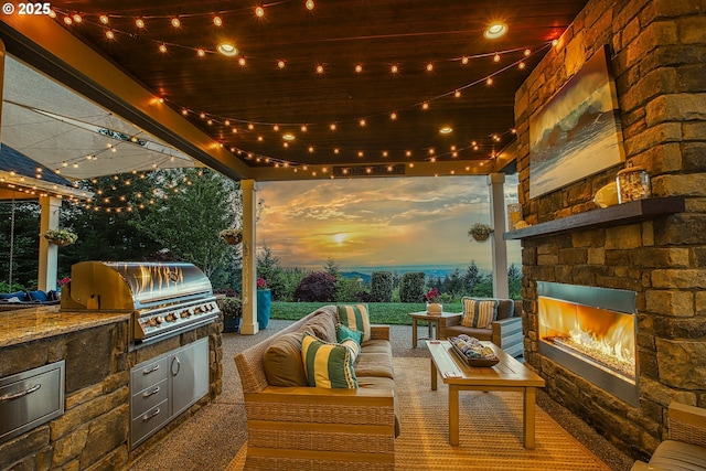 8627 NE Livingston Mountain Rd, Camas, WA 98607 - patio terrace at dusk with grilling area, an outdoor living space with a fireplace, and area for grilling