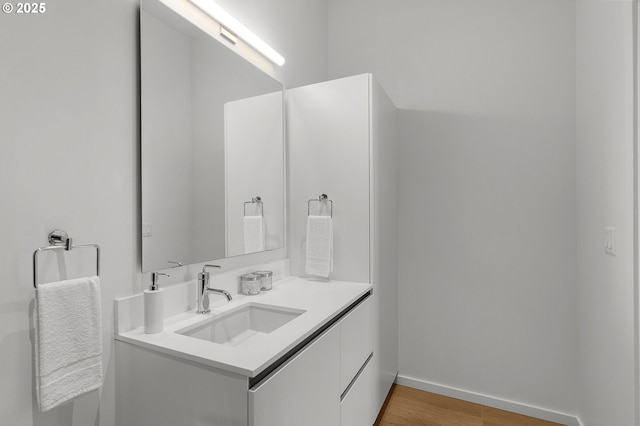 bathroom with vanity and hardwood / wood-style flooring