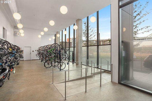 interior space with concrete floors and a wall of windows