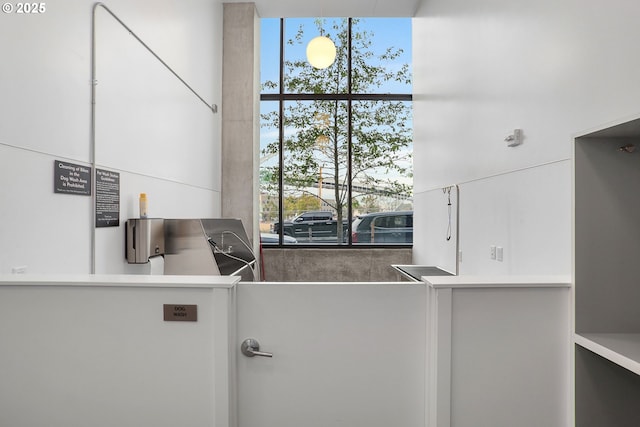 kitchen with white cabinets and a wall of windows