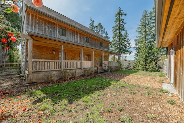 back of house featuring covered porch