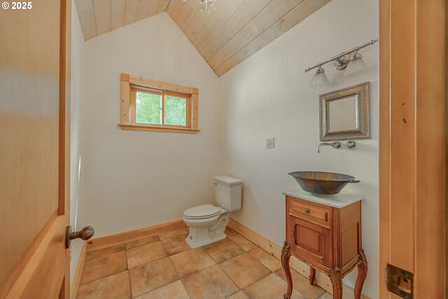 bathroom featuring vanity, toilet, baseboards, lofted ceiling, and wood ceiling