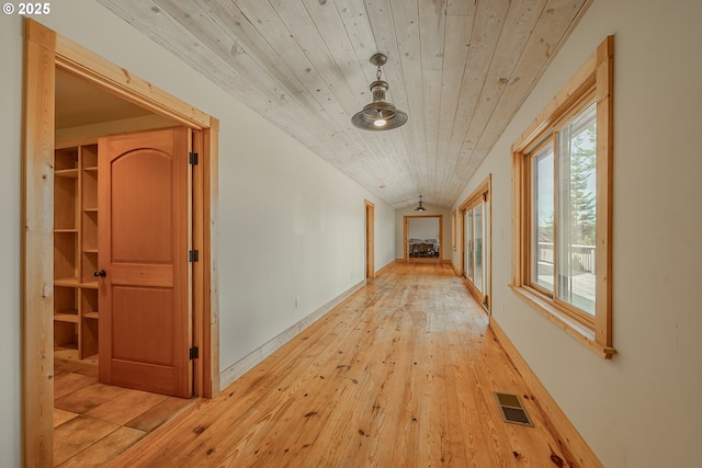 corridor featuring visible vents, wood ceiling, and light wood-type flooring