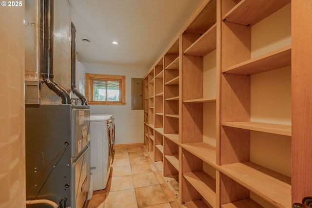 interior space featuring electric panel, independent washer and dryer, light tile patterned floors, baseboards, and recessed lighting