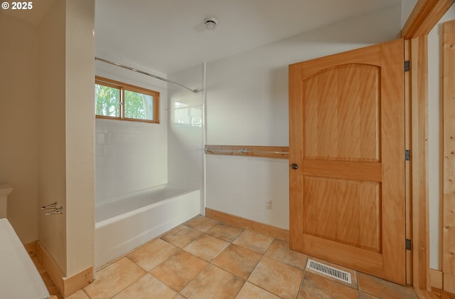 full bathroom with baseboards, visible vents, and bathtub / shower combination