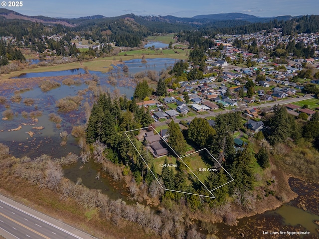 aerial view featuring a water and mountain view