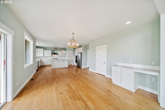 80654 Polo Ridge Rd, Warrenton, OR 97146 - unfurnished living room with a chandelier, light wood-style floors, and recessed lighting