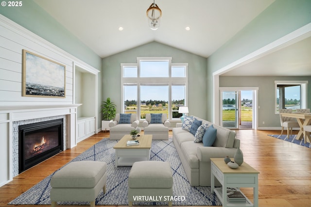 80654 Polo Ridge Rd, Warrenton, OR 97146 - living room with hardwood / wood-style floors, vaulted ceiling, and a fireplace