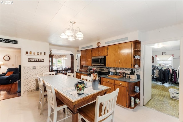 18050 SE Langensand Rd, Sandy, OR 97055 - kitchen with a chandelier, stainless steel appliances, open shelves, and brown cabinetry