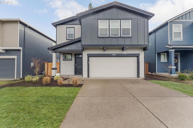 view of front of property with a front yard and a garage