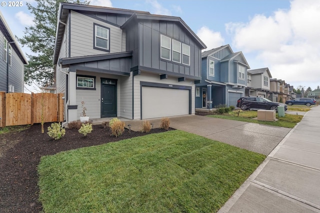 view of front of property with a front yard and a garage