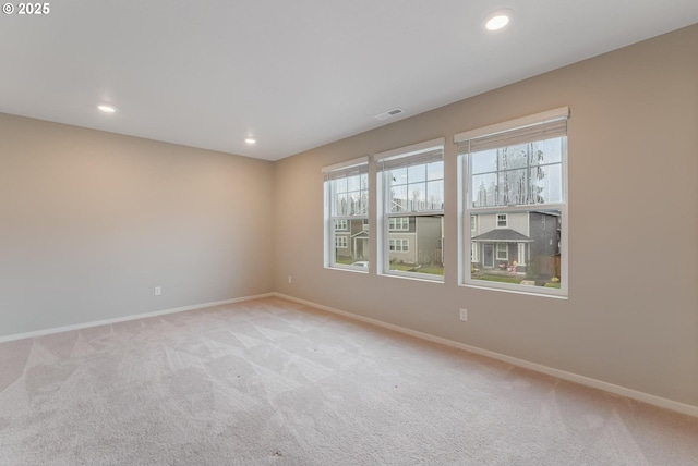 unfurnished room with light carpet