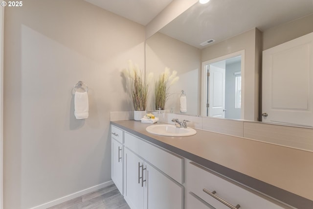 bathroom with hardwood / wood-style floors and vanity