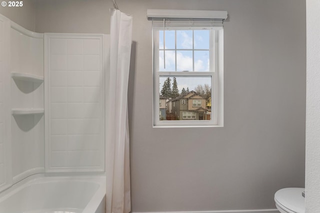 bathroom featuring toilet and shower / tub combo with curtain