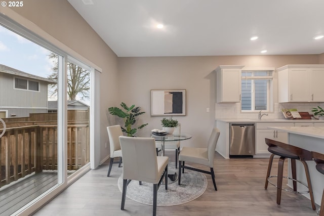 dining space with sink and light hardwood / wood-style flooring