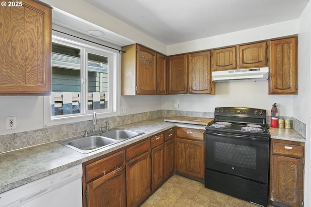 534 N 11th St, Saint Helens, OR 97051 - kitchen with black range with electric stovetop, under cabinet range hood, white dishwasher, light countertops, and brown cabinets