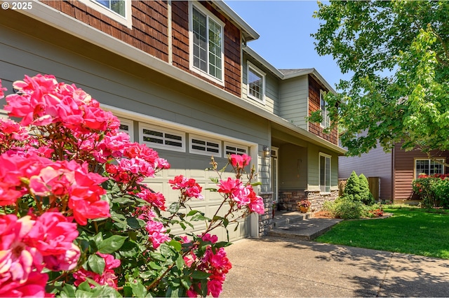 616 E 13th Pl, Lafayette, OR 97127 - view of property exterior with an attached garage, stone siding, and driveway