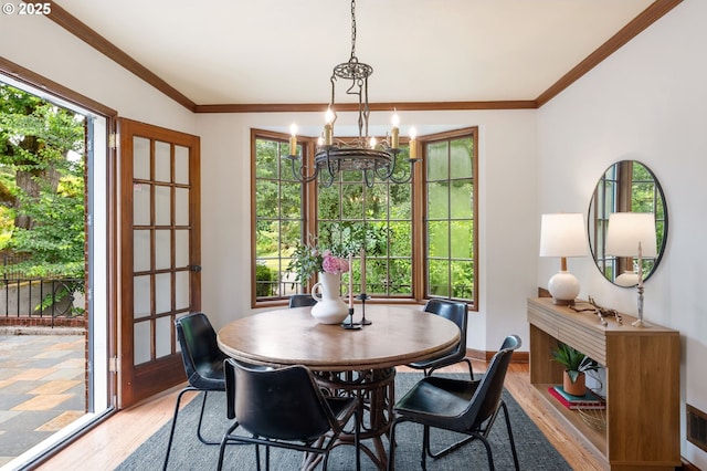 6040 SE 32nd Ave, Portland, OR 97202 - dining space featuring light wood-style floors, a chandelier, healthy amount of natural light, and ornamental molding