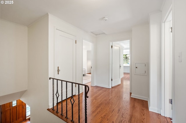 6040 SE 32nd Ave, Portland, OR 97202 - corridor with light wood finished floors, an upstairs landing, and crown molding