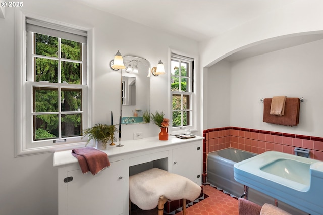6040 SE 32nd Ave, Portland, OR 97202 - full bathroom with a garden tub, healthy amount of natural light, vanity, wainscoting, and tile walls