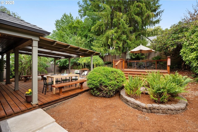 6040 SE 32nd Ave, Portland, OR 97202 - wooden terrace with outdoor dining area and a fenced backyard