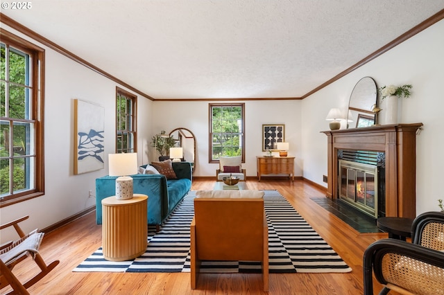 6040 SE 32nd Ave, Portland, OR 97202 - living room with a fireplace with flush hearth, crown molding, wood finished floors, and a textured ceiling