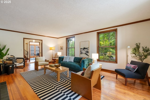 6040 SE 32nd Ave, Portland, OR 97202 - living area featuring light wood finished floors, healthy amount of natural light, a textured ceiling, and ornamental molding