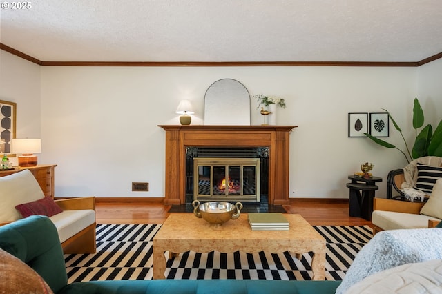 6040 SE 32nd Ave, Portland, OR 97202 - living area featuring wood finished floors, a fireplace with flush hearth, ornamental molding, and a textured ceiling