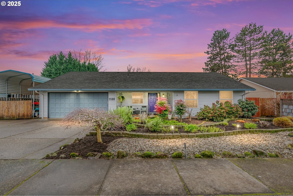 single story home with a garage and a carport