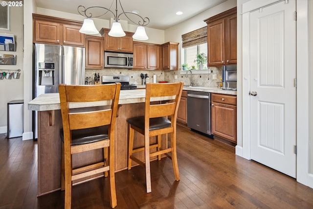19459 Leland Rd, Oregon City, OR 97045 - kitchen with stainless steel appliances, light countertops, dark wood-type flooring, decorative backsplash, and recessed lighting