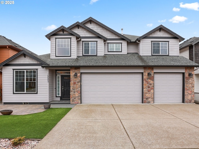 view of front facade featuring concrete driveway, an attached garage, roof with shingles, and stone siding