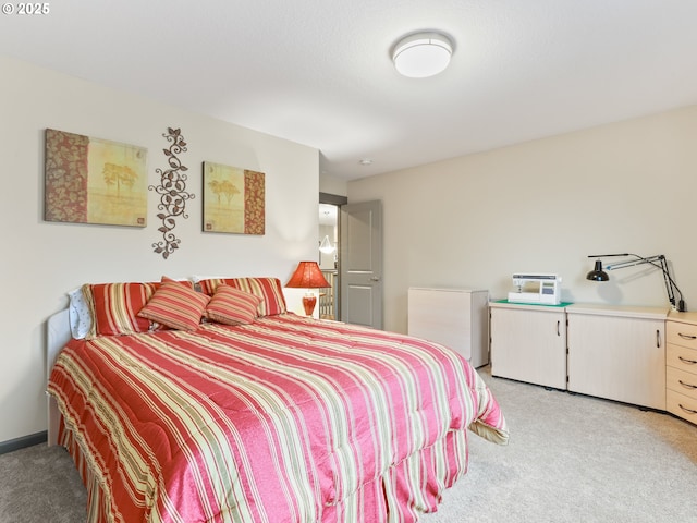 bedroom with light carpet and refrigerator