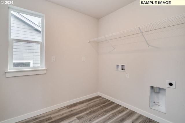 laundry room featuring hardwood / wood-style flooring, electric dryer hookup, and washer hookup