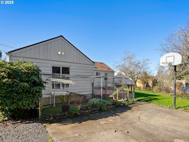 rear view of house with a lawn and a playground