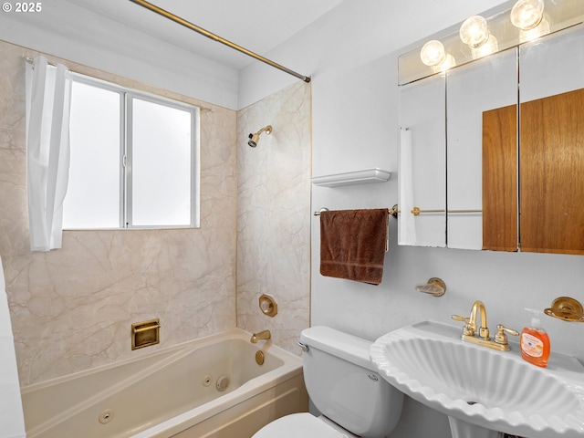 full bathroom featuring sink, toilet, and tiled shower / bath