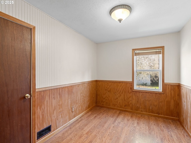 empty room with light hardwood / wood-style floors