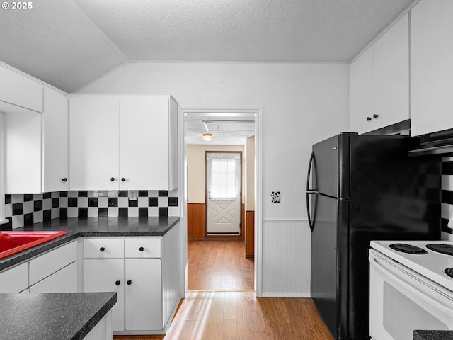 kitchen featuring a textured ceiling, white cabinets, white electric range oven, lofted ceiling, and light hardwood / wood-style floors