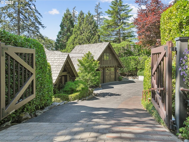 view of road with decorative driveway