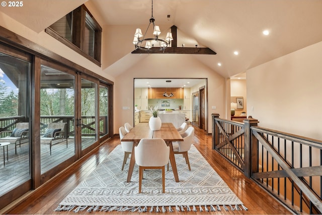 dining room featuring wood-type flooring, high vaulted ceiling, and a notable chandelier
