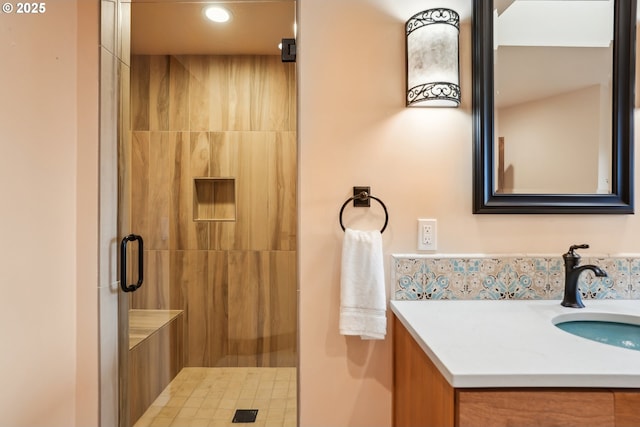 full bathroom with a shower stall and vanity