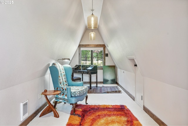 sitting room with visible vents, baseboards, and vaulted ceiling