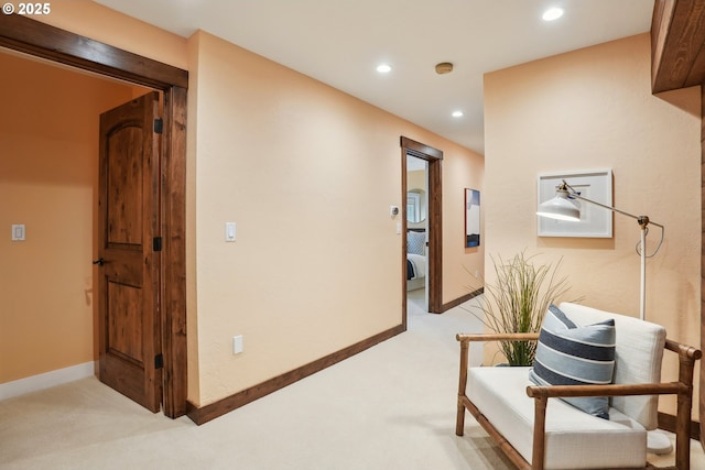 hall with light carpet, baseboards, and recessed lighting