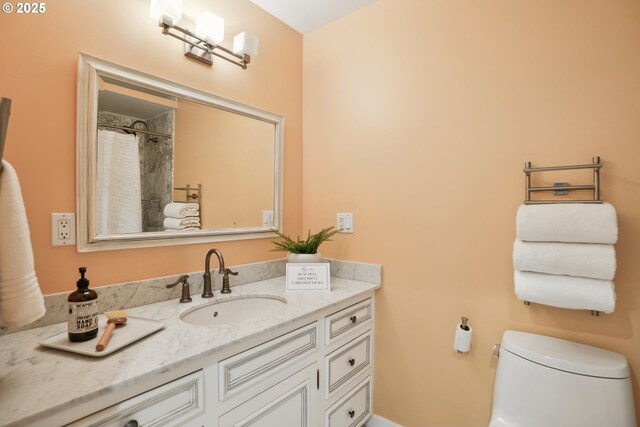 bathroom featuring toilet and vanity