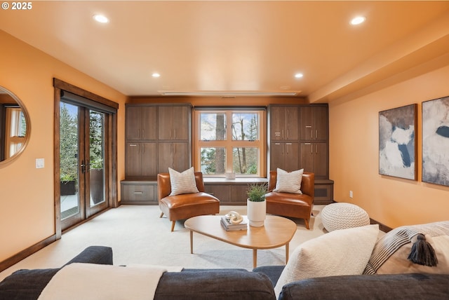living area with french doors, light colored carpet, and recessed lighting