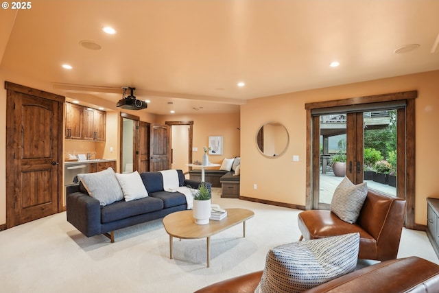 living area with light carpet, recessed lighting, and baseboards