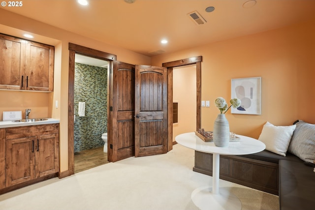 interior space with vanity, recessed lighting, walk in shower, toilet, and visible vents
