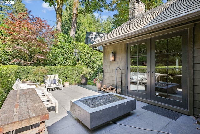 view of patio / terrace featuring an outdoor fire pit and french doors