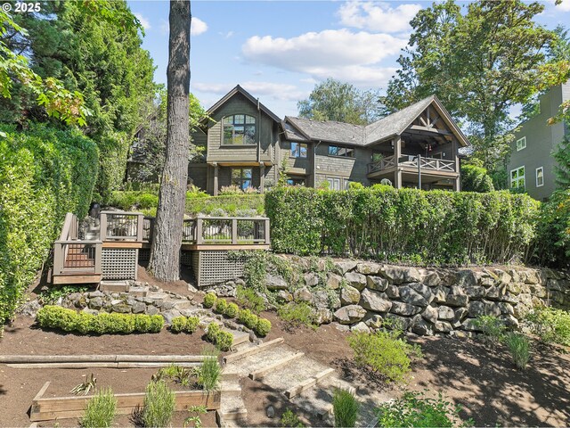 rear view of house with stairway and a wooden deck