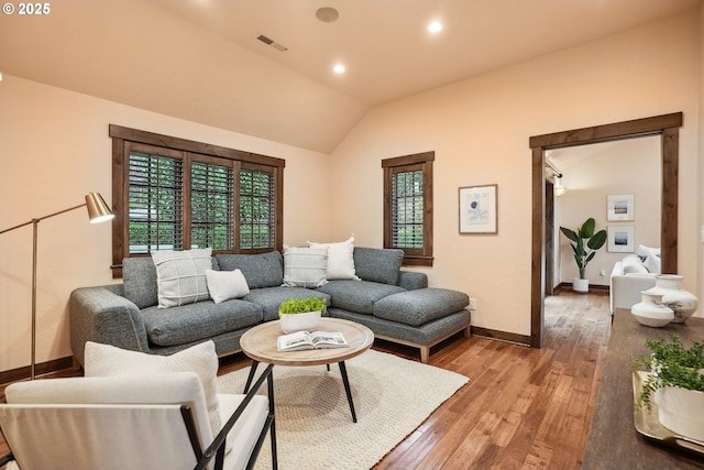living room featuring visible vents, wood-type flooring, and plenty of natural light