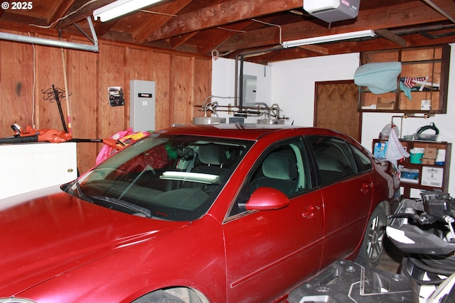 1783 View St, Myrtle Point, OR 97458 - garage with a garage door opener, electric panel, and wooden walls